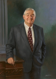 Portrait painting of Charles Grandison Rose III, three quarter length, in a suit and tie, holding eyeglasses and smiling, leaning against a carved wooden dais or desk